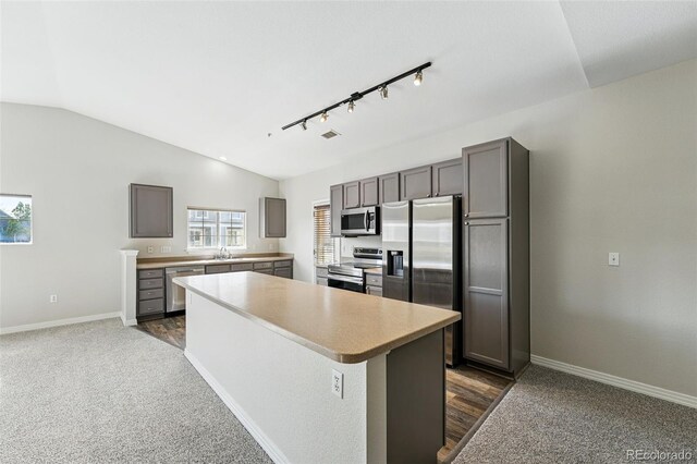 9434 Ashbury Cir Unit 203, Parker, CO 80134 - kitchen with appliances with stainless steel finishes, a sink, light countertops, lofted ceiling, and baseboards