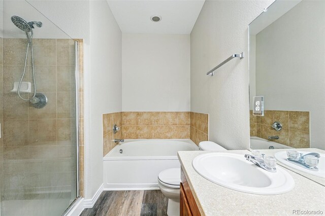 9434 Ashbury Cir Unit 203, Parker, CO 80134 - bathroom with wood finished floors, a stall shower, a garden tub, and vanity