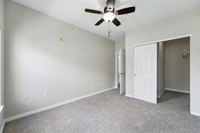 9434 Ashbury Cir Unit 203, Parker, CO 80134 - unfurnished bedroom featuring carpet flooring, baseboards, a closet, and ceiling fan