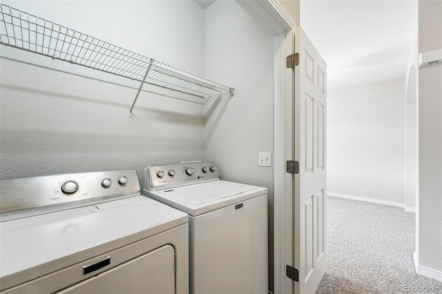 9434 Ashbury Cir Unit 203, Parker, CO 80134 - laundry room featuring separate washer and dryer, baseboards, and light colored carpet