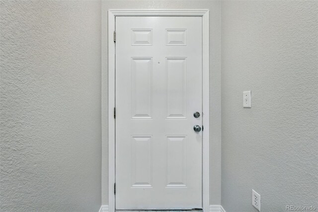 9434 Ashbury Cir Unit 203, Parker, CO 80134 - entryway featuring a textured wall and baseboards