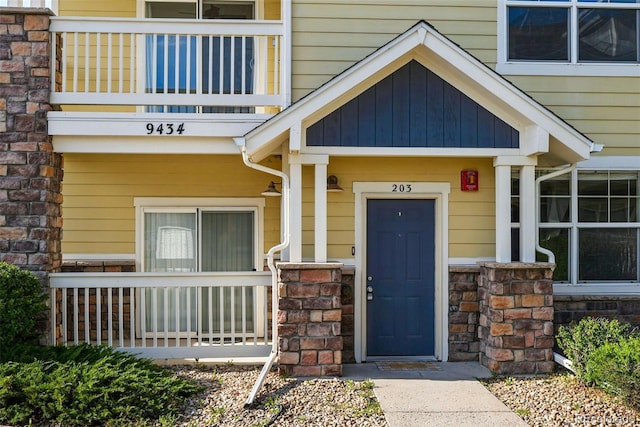 9434 Ashbury Cir Unit 203, Parker, CO 80134 - view of exterior entry with a balcony and covered porch