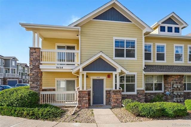 9434 Ashbury Cir Unit 203, Parker, CO 80134 - view of front of house with a balcony, a porch, and stone siding