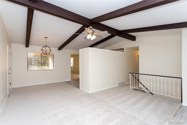 carpeted spare room with ceiling fan with notable chandelier and vaulted ceiling with beams