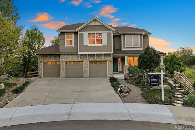 craftsman-style house with driveway, brick siding, an attached garage, and roof with shingles