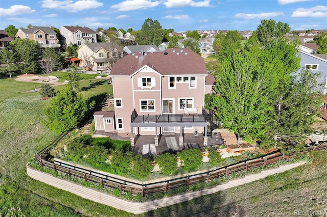 back of property featuring a patio, a residential view, and stucco siding