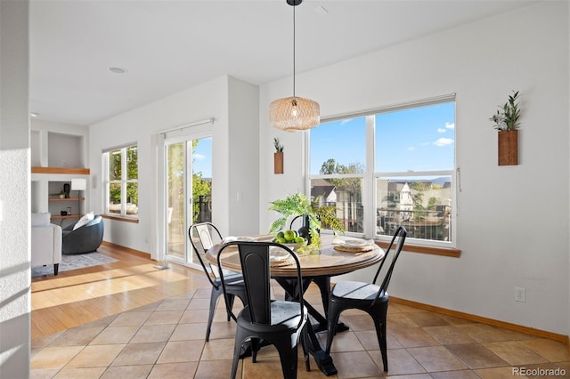 dining area featuring baseboards and light tile patterned floors