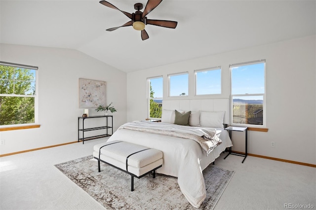carpeted bedroom featuring vaulted ceiling, multiple windows, baseboards, and ceiling fan