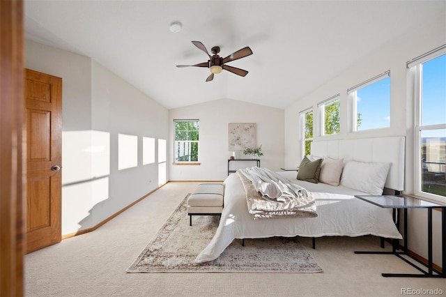 carpeted bedroom featuring vaulted ceiling, a ceiling fan, and baseboards