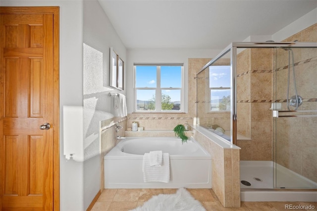 full bathroom with a stall shower and a garden tub