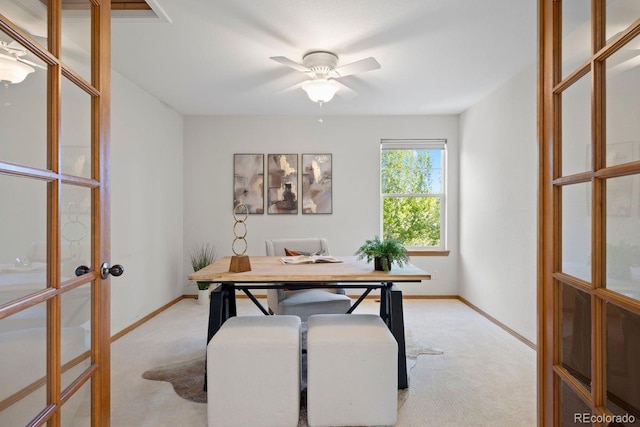 home office with french doors, light carpet, a ceiling fan, and baseboards