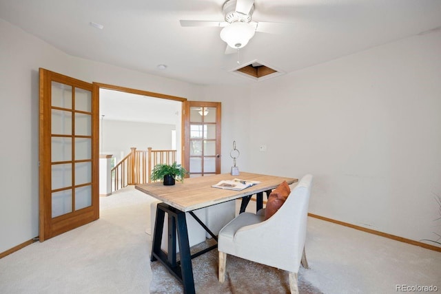office space with light colored carpet, baseboards, and a ceiling fan