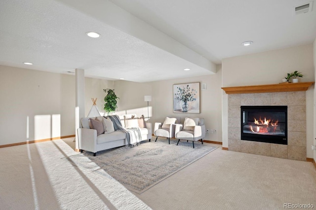 carpeted living room featuring recessed lighting, a tile fireplace, and baseboards