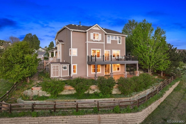 rear view of property with a storage shed, an outdoor structure, a patio area, and fence