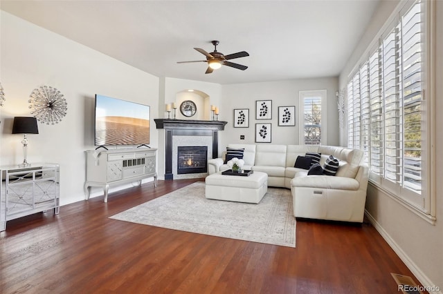 living room with ceiling fan and dark hardwood / wood-style flooring