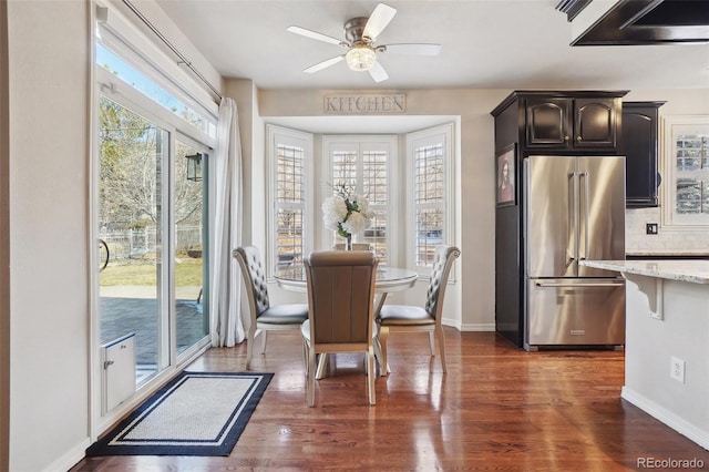 dining area featuring a healthy amount of sunlight, dark wood-type flooring, and ceiling fan