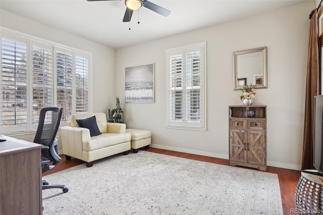 office area with dark wood-type flooring and ceiling fan