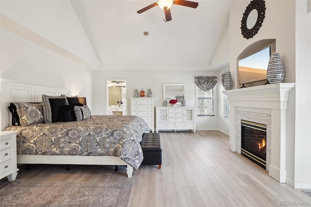 bedroom with ensuite bathroom, light wood-type flooring, high vaulted ceiling, and ceiling fan