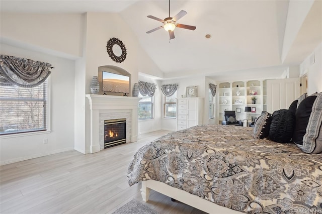 bedroom featuring ceiling fan, high vaulted ceiling, and light wood-type flooring