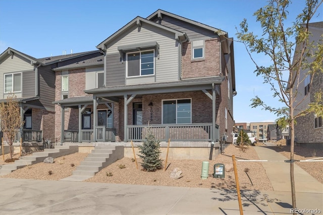 view of front of property with brick siding and covered porch