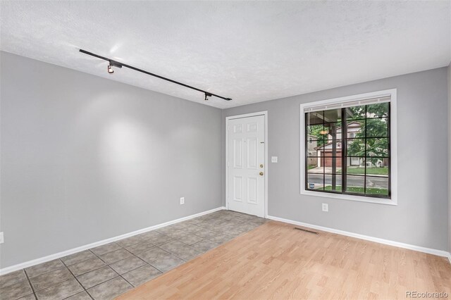 9328 Fenton Ct, Westminster, CO 80031 - empty room with wood finished floors, a textured ceiling, and track lighting