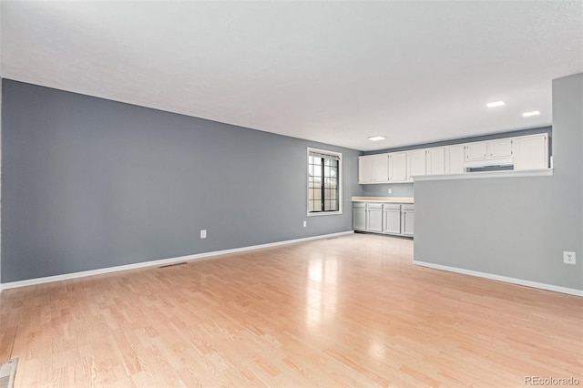 9328 Fenton Ct, Westminster, CO 80031 - unfurnished living room with light wood-style flooring and baseboards
