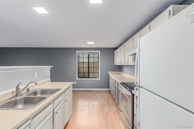9328 Fenton Ct, Westminster, CO 80031 - kitchen with freestanding refrigerator, electric stove, light wood finished floors, white cabinets, and under cabinet range hood