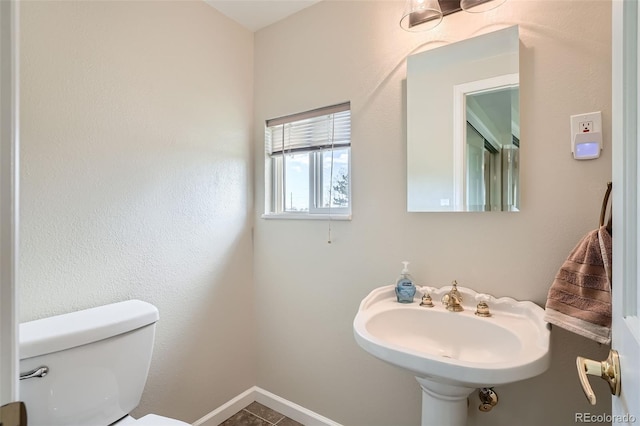 13805 W 82nd Ave, Arvada, CO 80005 - bathroom with toilet, baseboards, a sink, and tile patterned floors