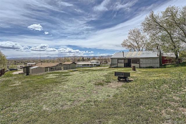 view of yard with a pole building and an outbuilding