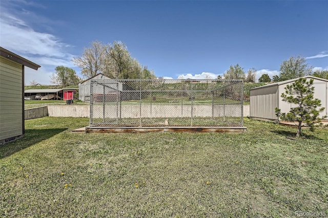 view of yard with a storage shed, fence, and an outdoor structure