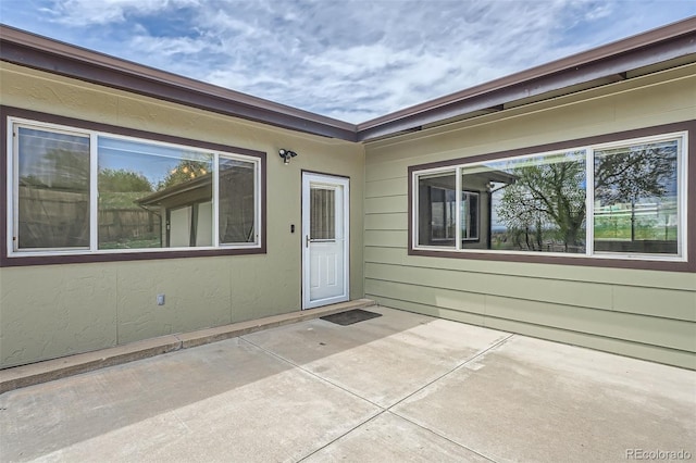 doorway to property with a patio