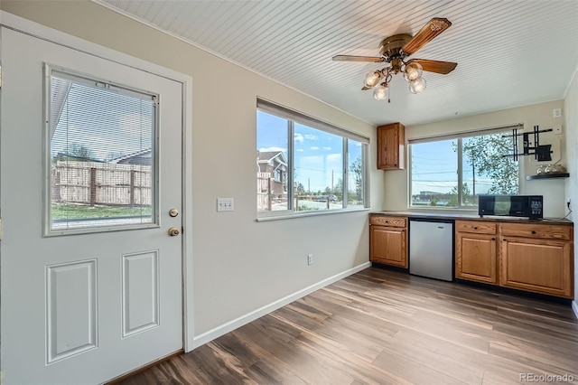 kitchen featuring ceiling fan, black microwave, brown cabinets, wood finished floors, and dishwasher