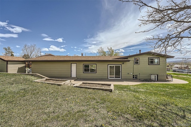 13805 W 82nd Ave, Arvada, CO 80005 - back of property featuring a lawn and a patio