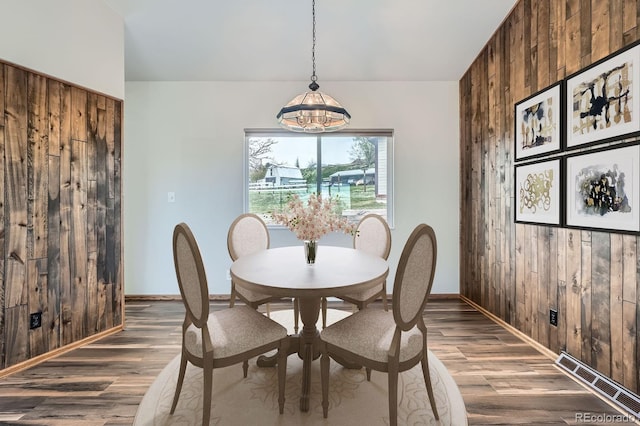 13805 W 82nd Ave, Arvada, CO 80005 - dining room featuring visible vents, wood walls, baseboards, and wood finished floors