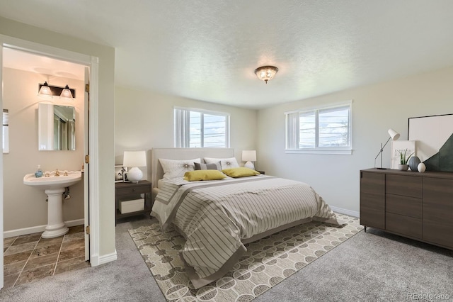 13805 W 82nd Ave, Arvada, CO 80005 - bedroom featuring baseboards, carpet flooring, and connected bathroom