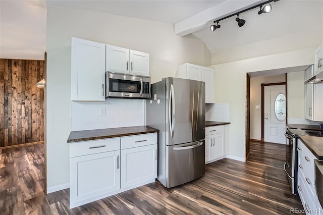 13805 W 82nd Ave, Arvada, CO 80005 - kitchen with white cabinetry, dark wood finished floors, backsplash, vaulted ceiling, and stainless steel appliances