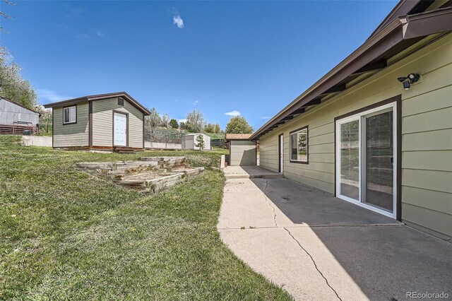 13805 W 82nd Ave, Arvada, CO 80005 - view of yard featuring an outdoor structure, a patio area, and a shed