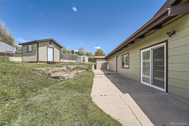 13805 W 82nd Ave, Arvada, CO 80005 - view of grassy yard with a storage unit and a patio area