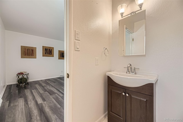 1477 S Wright St, Lakewood, CO 80228 - bathroom with vanity, wood finished floors, and baseboards