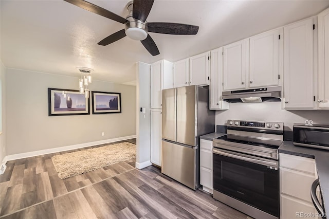 1477 S Wright St, Lakewood, CO 80228 - kitchen with stainless steel appliances, under cabinet range hood, white cabinets, dark countertops, and a ceiling fan