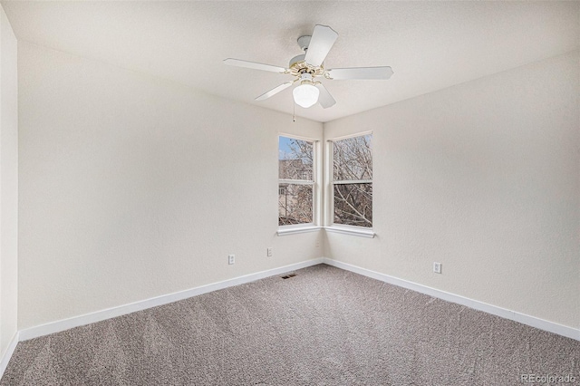 unfurnished room featuring a ceiling fan, carpet, visible vents, and baseboards