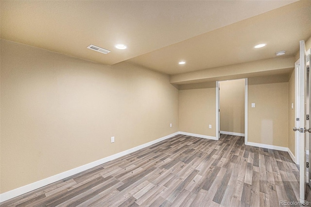 interior space featuring recessed lighting, wood finished floors, visible vents, and baseboards