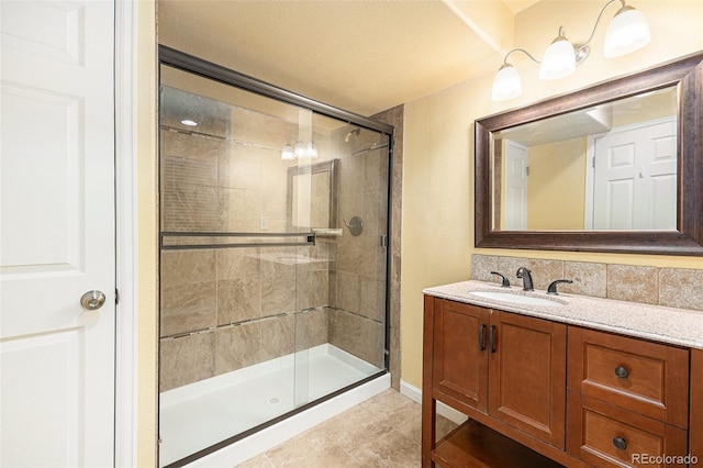 bathroom with a shower stall and vanity