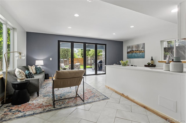 living room with french doors and light tile patterned floors