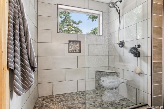 bathroom with tiled shower