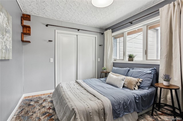 bedroom with hardwood / wood-style flooring and a closet