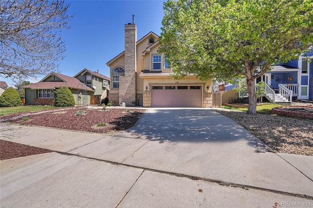 view of front of home with a chimney, concrete driveway, stucco siding, and a garage