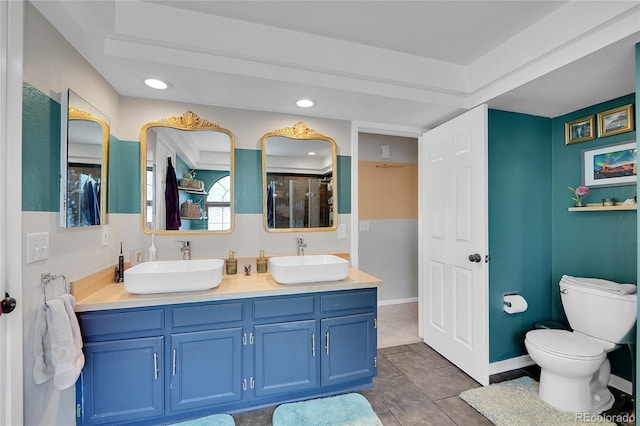 full bathroom with a stall shower, recessed lighting, toilet, double vanity, and tile patterned floors