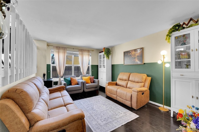 living room featuring dark wood-style flooring and baseboards