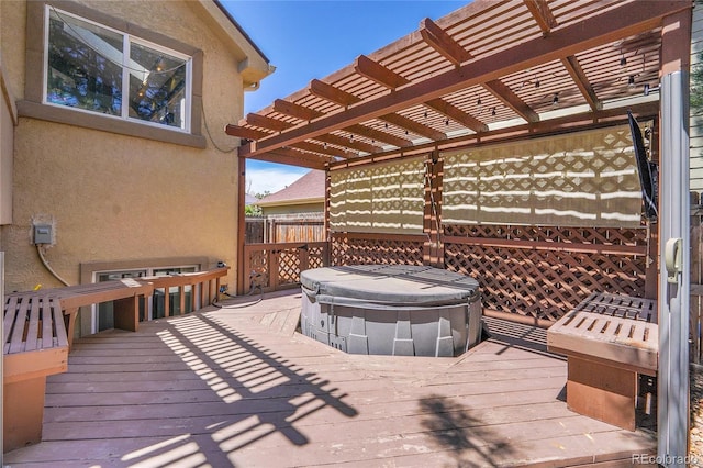 wooden terrace featuring a hot tub and a pergola